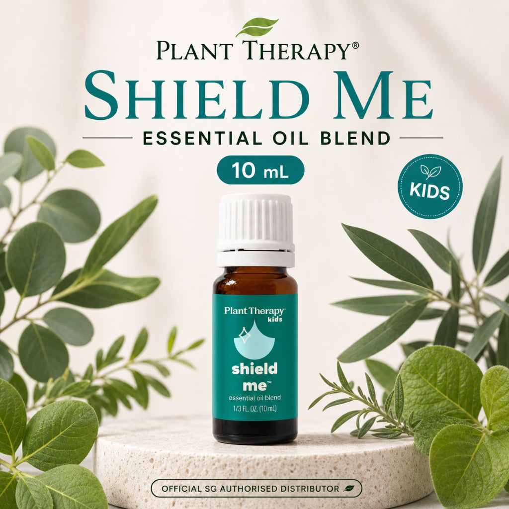 Plant Therapy KidSafe Shield Me Essential Oil Blend 10ml bottle surrounded by green leaves